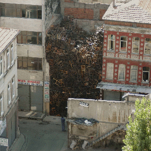 Doris Salcedo, 1550 Chairs Stacked Between Two City Buildings, 2003